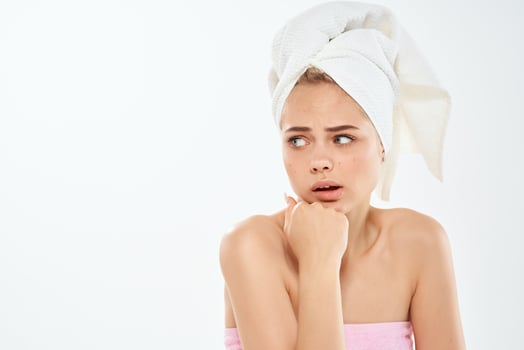 woman with a towel on her head bare shoulders close-up clean skin photo
