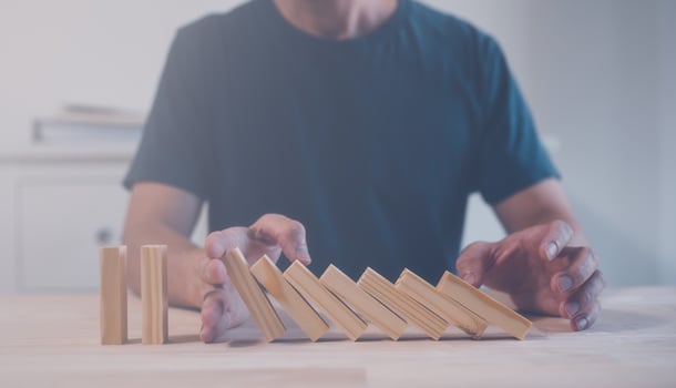 risk management concept, businessman stopping wooden blocks collapse or falling domino effect photo