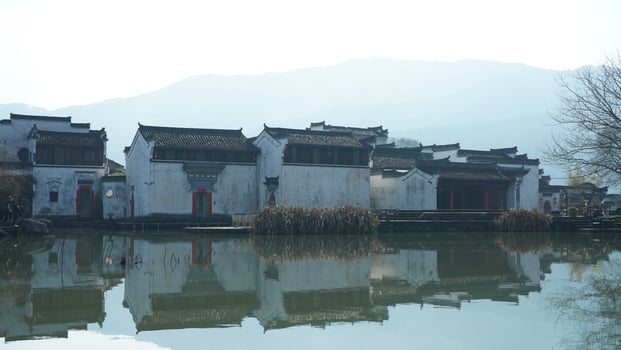 One old traditional Chinese village view with the old arched stone bridge and old wooden buildings in the Southern countryside of the China photo