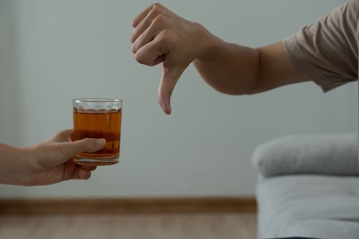 man refuses say no and avoid to drink an alcohol whiskey , stopping hand sign male, alcoholism treatment, alcohol addiction, quit booze, Stop Drinking Alcohol. Refuse Glass liquor, unhealthy, reject photo