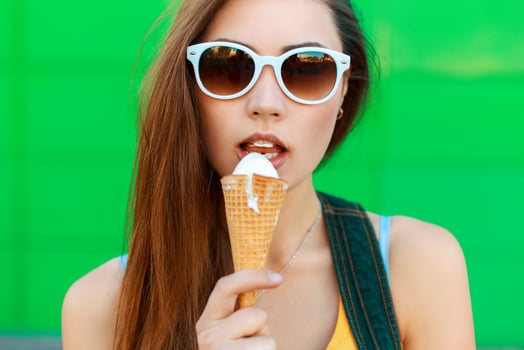 Pretty young woman eating ice cream. photo