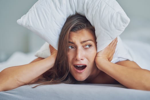 Young nice brunette woman with pillow on bed photo
