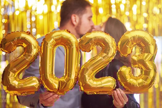 Couple at new year eve party with gold balloons photo