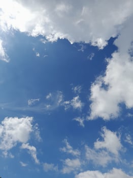 Beautiful white clouds on deep blue sky background. Large bright soft fluffy clouds are cover the entire blue sky. photo