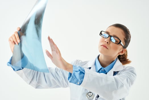 woman doctor in white coat looking at x-ray diagnostics close-up photo