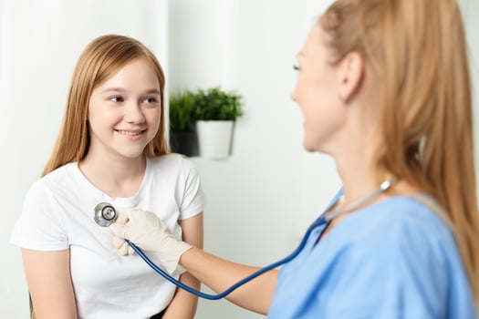 woman doctor examining a child stethoscope hospital photo