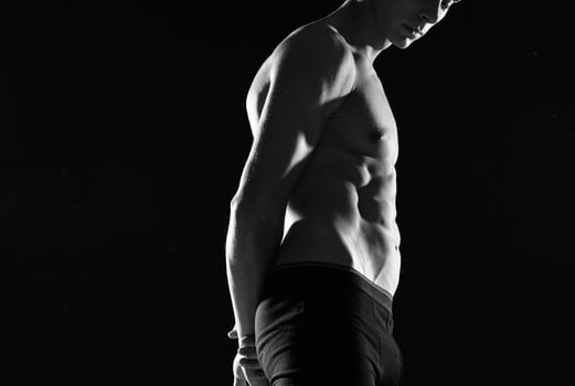 muscular man in black shorts gym black and white photo