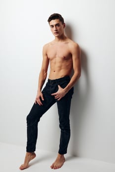 sexy guy in jeans and naked torso light background photo