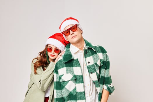 Fashion young couple in sunglasses hugs holiday Christmas photo