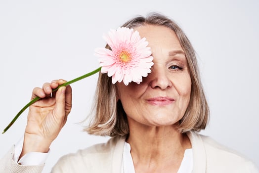elderly woman in white robe flower care holiday photo