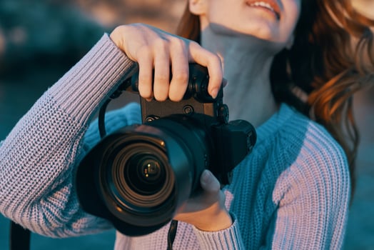 woman photographer with camera in nature Professional photo