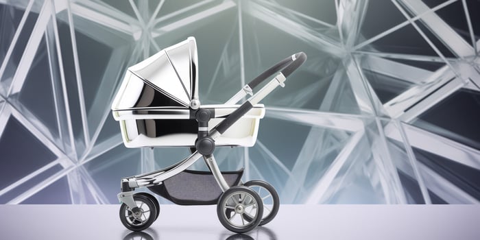 Modern chrome metal baby stroller on a futuristic photo