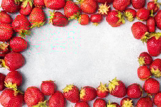 Frame Juicy ripe strawberries on a concrete background. Sweet healthy dessert, vitamin harvest. copy space. photo