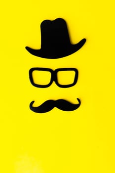 Happy fathers day sticker, hat, glasses, black mustache on a yellow background. Hipster objects. Father is day is a holiday. photo