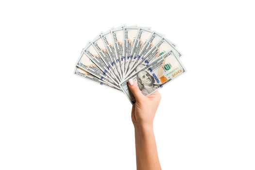 Top view of isolated female hand holding a fan of one hundred dollar bills. Wealth and rich concept photo