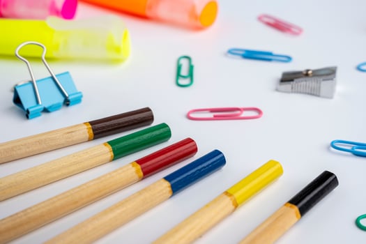 stationery, colored pencils and pencil sharpener, text separators and paper clips photo