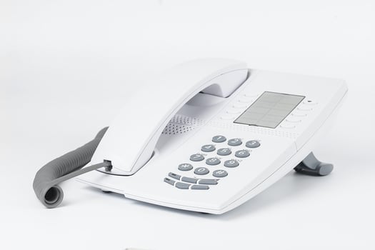 White office desk phone isolated on white photo