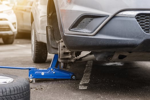 Car wheel replacement. Self-service tire fitting concept. Using a wheel wrench to twist the wheel nuts. photo