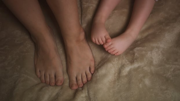 Cute little baby feet in white blanket photo