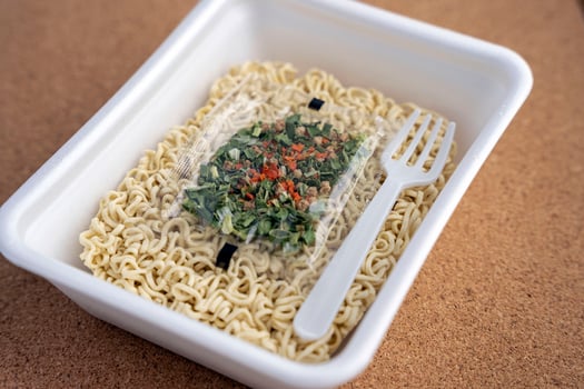 Chinese noodles with a bag of dried vegetables. close-up. Instant noodles photo
