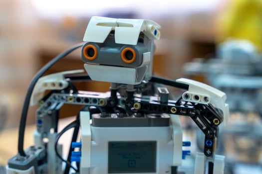 programmable children's robot with a head assembled from designer photo