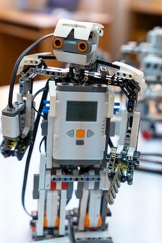 programmable children's robot with a head assembled from designer photo