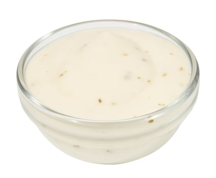 White sauce based on mayonnaise with dried herbs on a white background photo