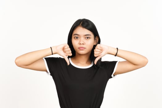 Showing Thumbs Down Sign Of Beautiful Asian Woman Isolated On White Background photo