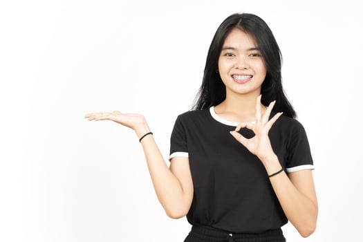 Showing and Presenting Product on Open Palm with ok sign Of Beautiful Asian Woman Isolated On White photo