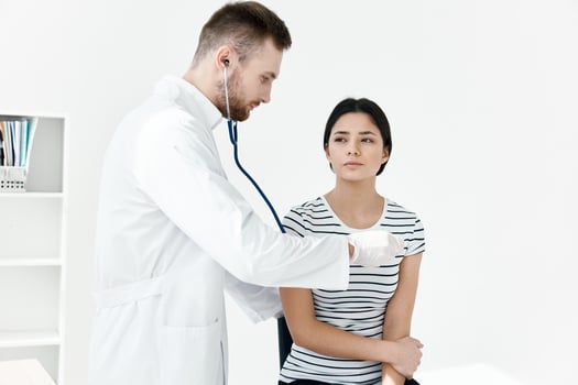 male doctor examines patient in hospital health photo