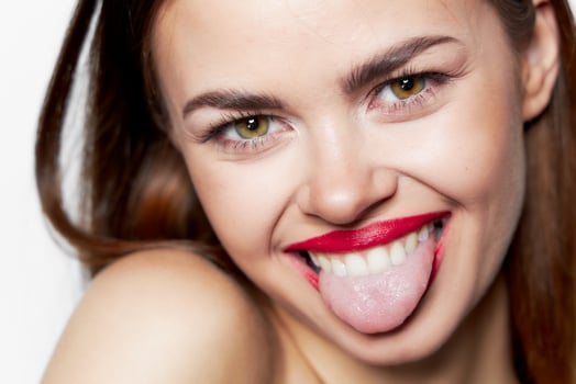 Cheerful woman shows tongue face close up joy photo