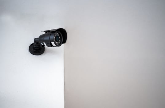 CCTV cameras installed on a white wall. Concept of surveillance and monitoring. photo