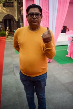 New Delhi, India - March 04 2023 - Unidentified people showing their ink-marked fingers after casting votes in front of polling booth of east Delhi area for MCD local body Elections 2022 photo