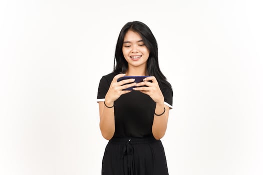 Smiling and Playing Mobile Game on Smartphone Of Beautiful Asian Woman Isolated On White Background photo