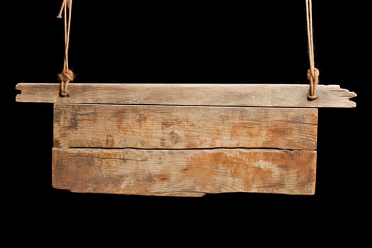 Wooden sign plain hanging from rope isolated on black background. photo