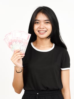 Holding 100000 Rupiah Banknote of Beautiful Asian Woman Isolated On White Background photo