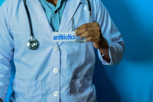 Doctor holding a card with text Antibiotics. Medical and healthcare concept. photo