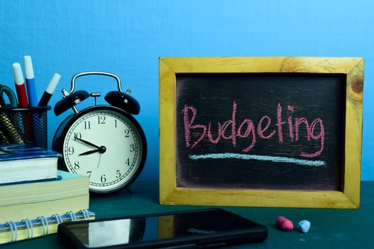 Budgeting Planning on Background of Working Table with Office Supplies. Business Concept Planning on Blue Background photo
