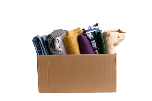 Woman packs clothes in boxes for donating. photo