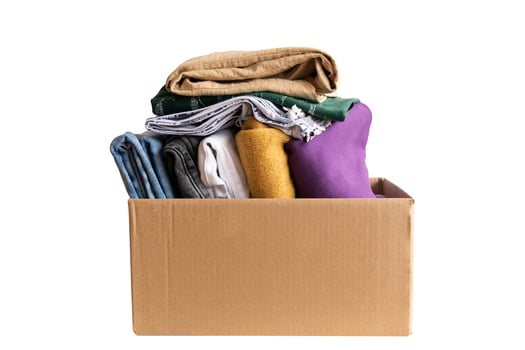 Woman packs clothes in boxes for donating. photo