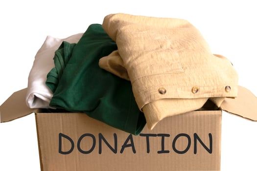 Woman packs clothes in boxes for donating. photo