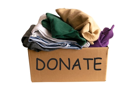 Woman packs clothes in boxes for donating. photo
