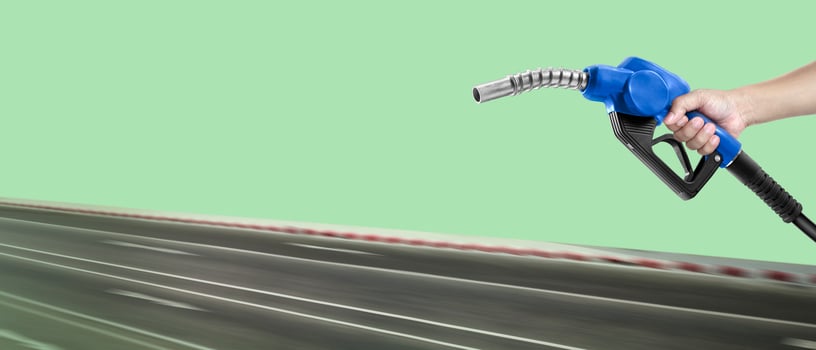 Hands holding a fuel nozzle and the blur the street photo