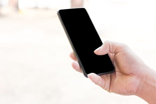 Close up view of man hand holding smartphone with blur background on black screen of on phone with copy space for business or social media internet  communication of technology photo