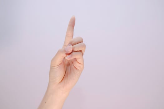 Index finger sign on white isolated background, feman pointing at something closeup of hand photo