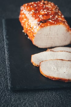 Baked meat on the black sone board photo