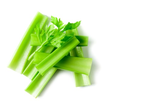 Fresh sliced green celery isolated on white photo