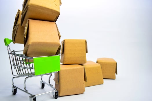 Many small boxes and shopping cart. Concepts about online shopping. Isolated on white background photo