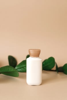 Natural cosmetic cream for beauty, skin care. an empty bottle with grass leaves in the background. bio organic product. photo