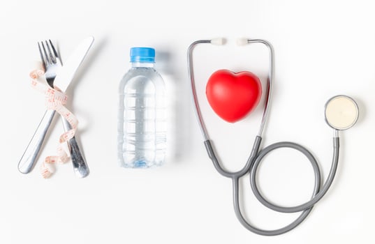 water and stethoscope with red heart isolated photo